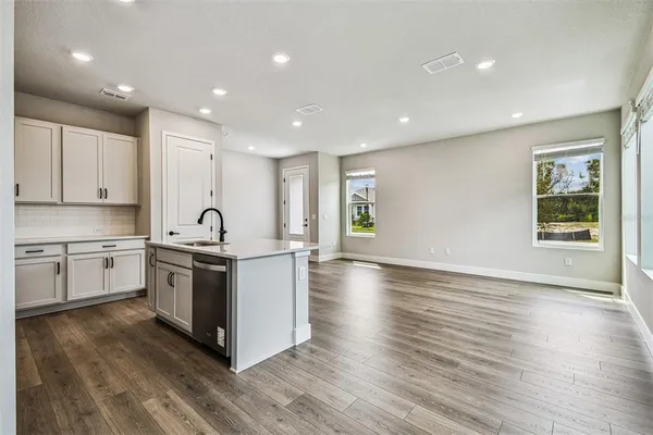 a view of kitchen with sink and wooden floor