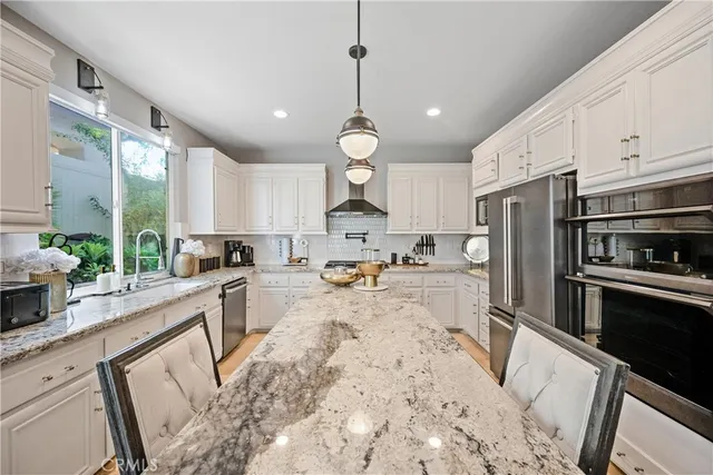 a view of a kitchen with sink microwave and refrigerator