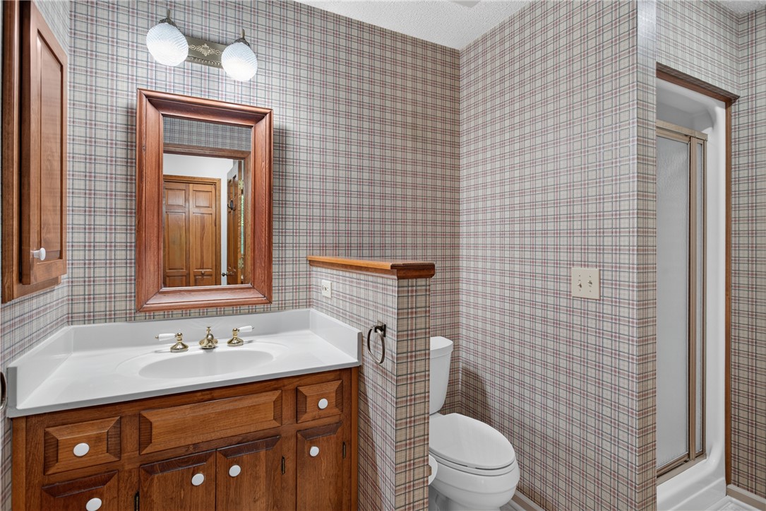 12 Lookout Lane Salem, SC 29676 - Photo 21 of 47 A classic plaid-patterned bathroom featuring a wooden vanity and a convenient shower adjacent to garage for quick cleanup.