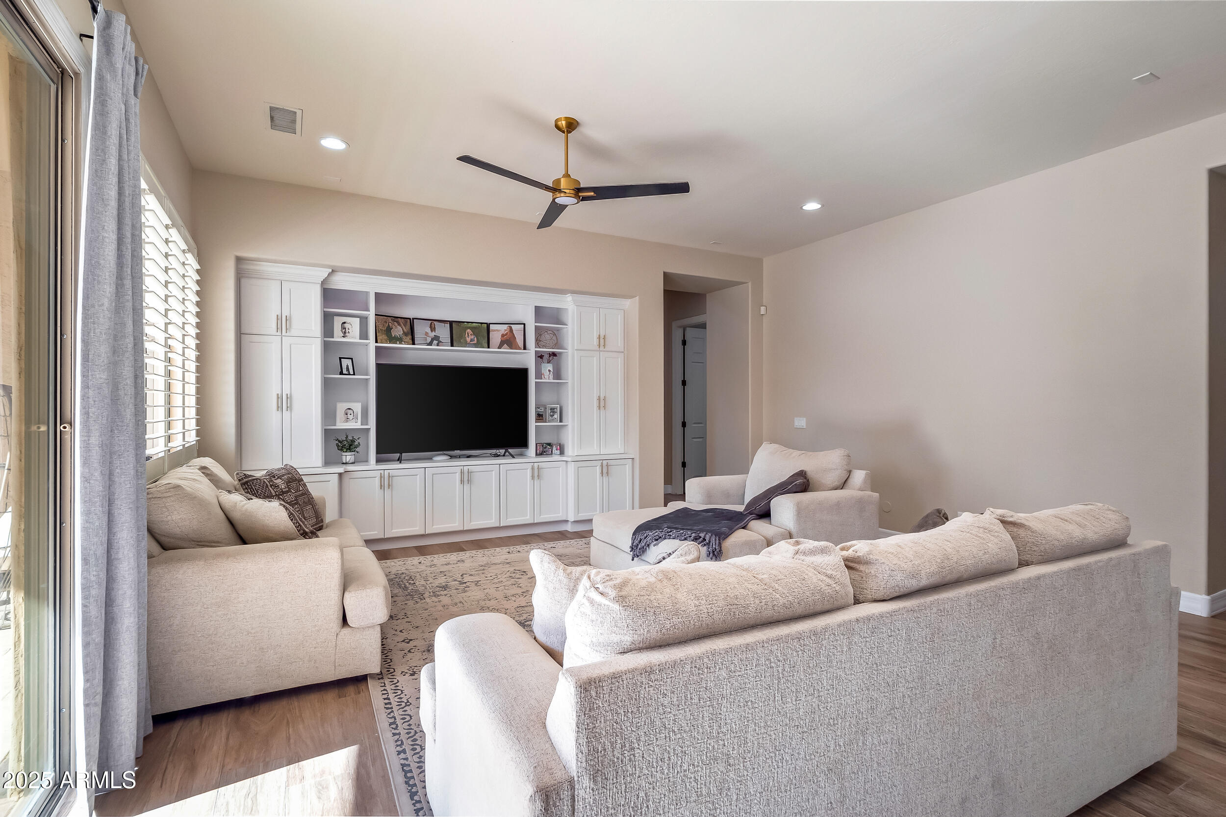 2955 East Blue Sage Road Gilbert, AZ 85297 - Photo 18 of 55 a living room with furniture and a flat screen tv