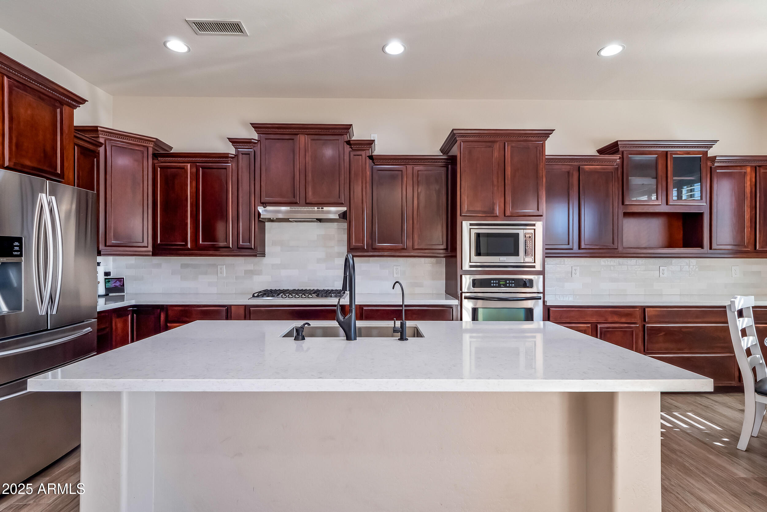 2955 East Blue Sage Road Gilbert, AZ 85297 - Photo 21 of 55 a kitchen with stainless steel appliances a sink and a refrigerator