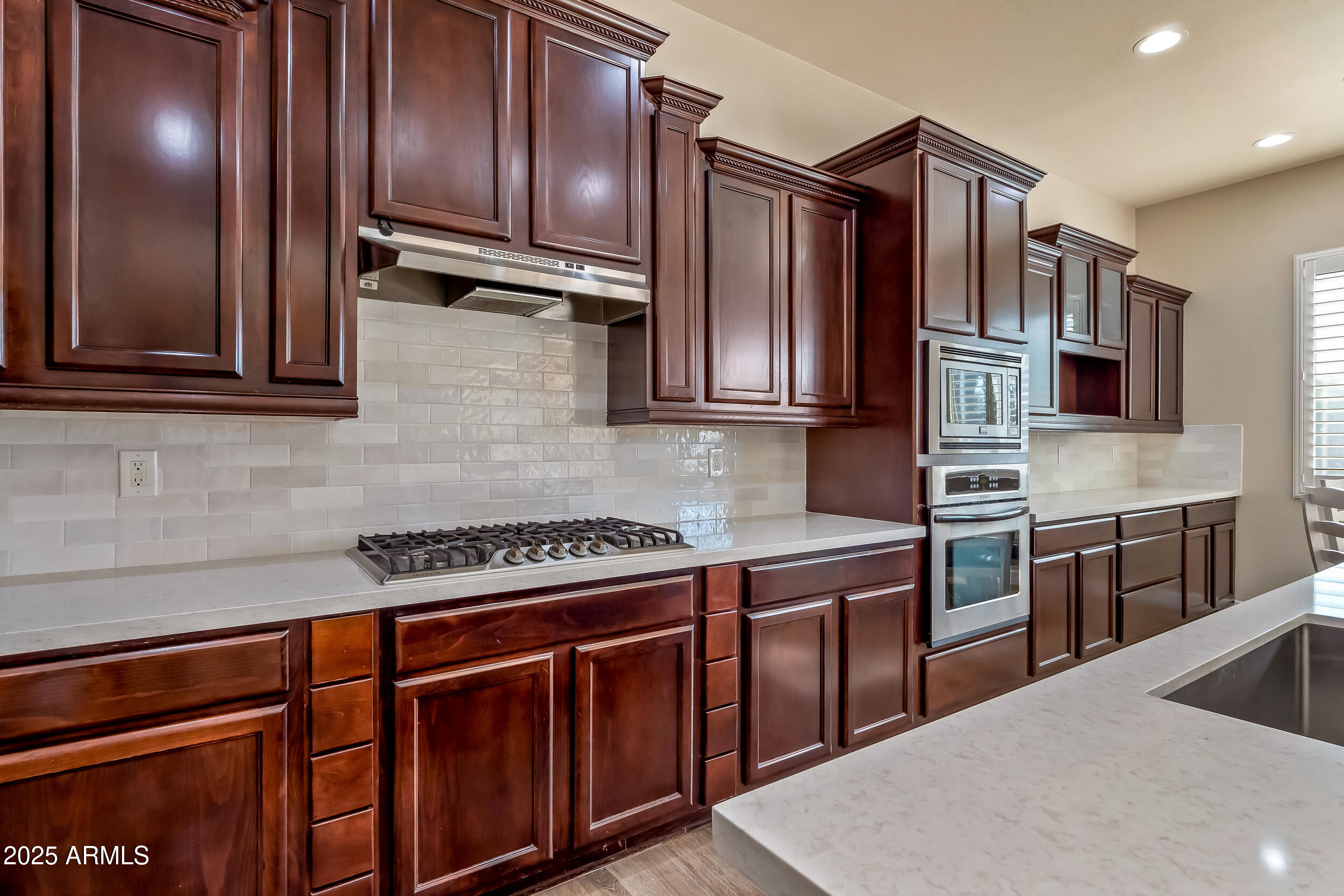 2955 East Blue Sage Road Gilbert, AZ 85297 - Photo 23 of 55 a kitchen with stainless steel appliances granite countertop a stove a sink and dishwasher