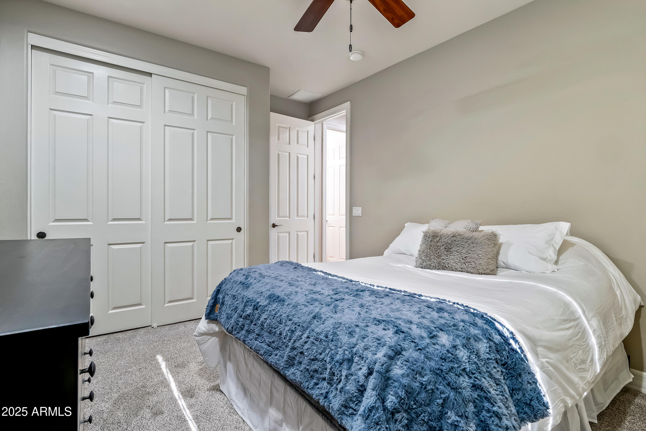 2955 East Blue Sage Road Gilbert, AZ 85297 - Photo 42 of 55 a spacious bedroom with a bed and cabinet