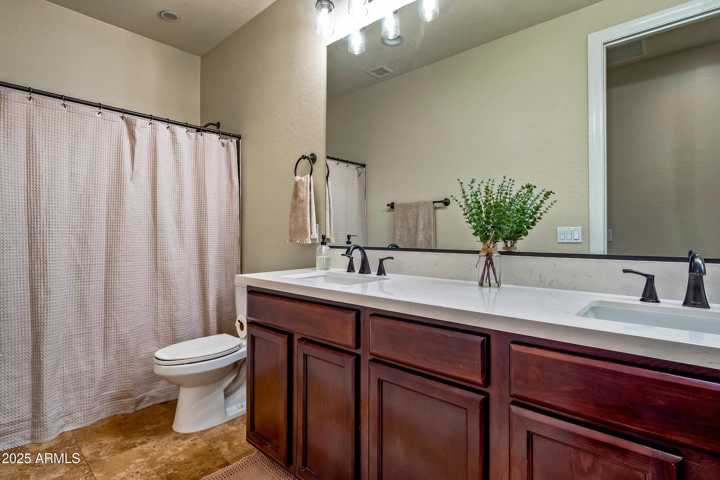 2955 East Blue Sage Road Gilbert, AZ 85297 - Photo 45 of 55 a bathroom with a granite countertop sink a toilet and a mirror