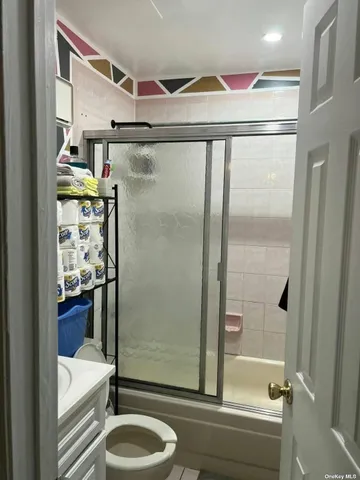 a bathroom with a granite countertop shower sink and mirror