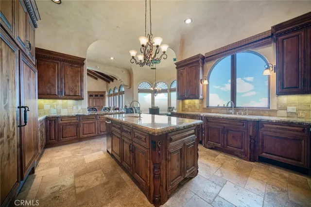 a living room with fireplace furniture and a large window