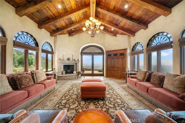 a bedroom with furniture and a large window