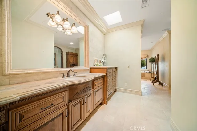 a bathroom with a granite countertop sink a mirror and a shower