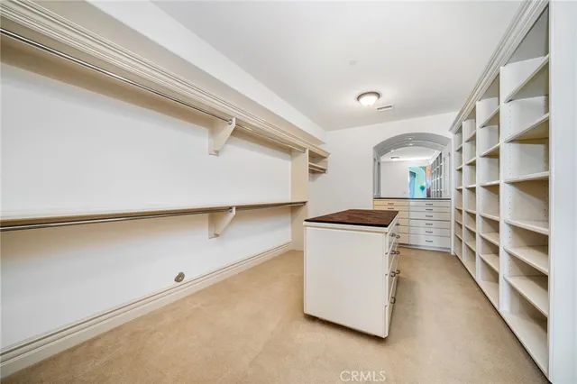 a spacious bedroom with a bed and large windows