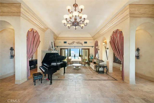 a living room with furniture and a chandelier