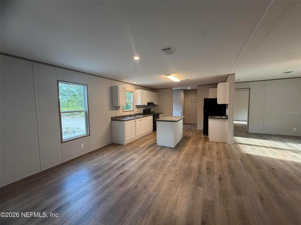 114 Nutmeg Trail Interlachen, FL 32148 - Photo 18 of 33 a view of kitchen with wooden floor and electronic appliances