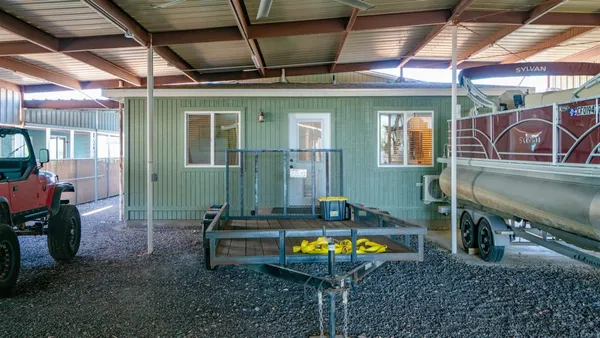 a kitchen with stainless steel appliances granite countertop a refrigerator a sink dishwasher a stove and white countertops with wooden floor