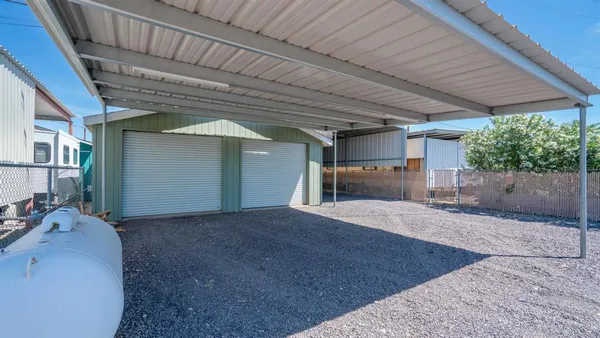 a living room with furniture ceiling fan and a large window