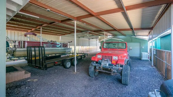 a bedroom with a bed and a mirror on the dresser