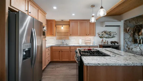 an aerial view of residential houses with outdoor space and ocean view
