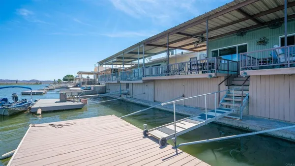 a view of a porch with furniture and wooden floor