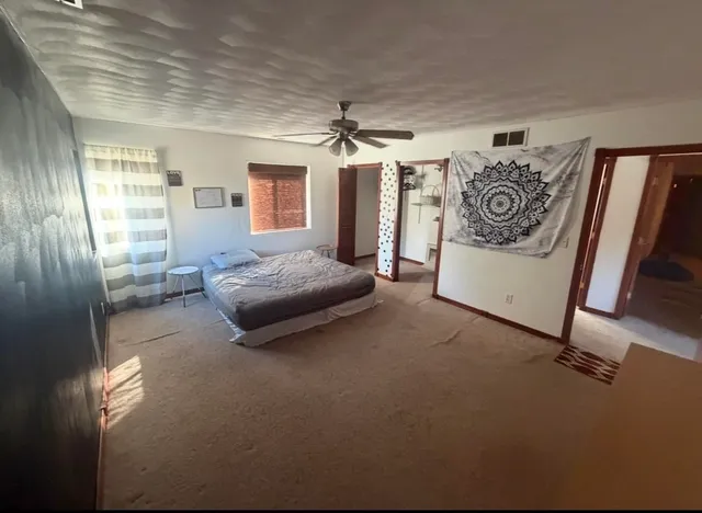 a bedroom with furniture and a window