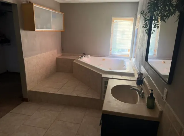 a bathroom with a sink a washer and dryer