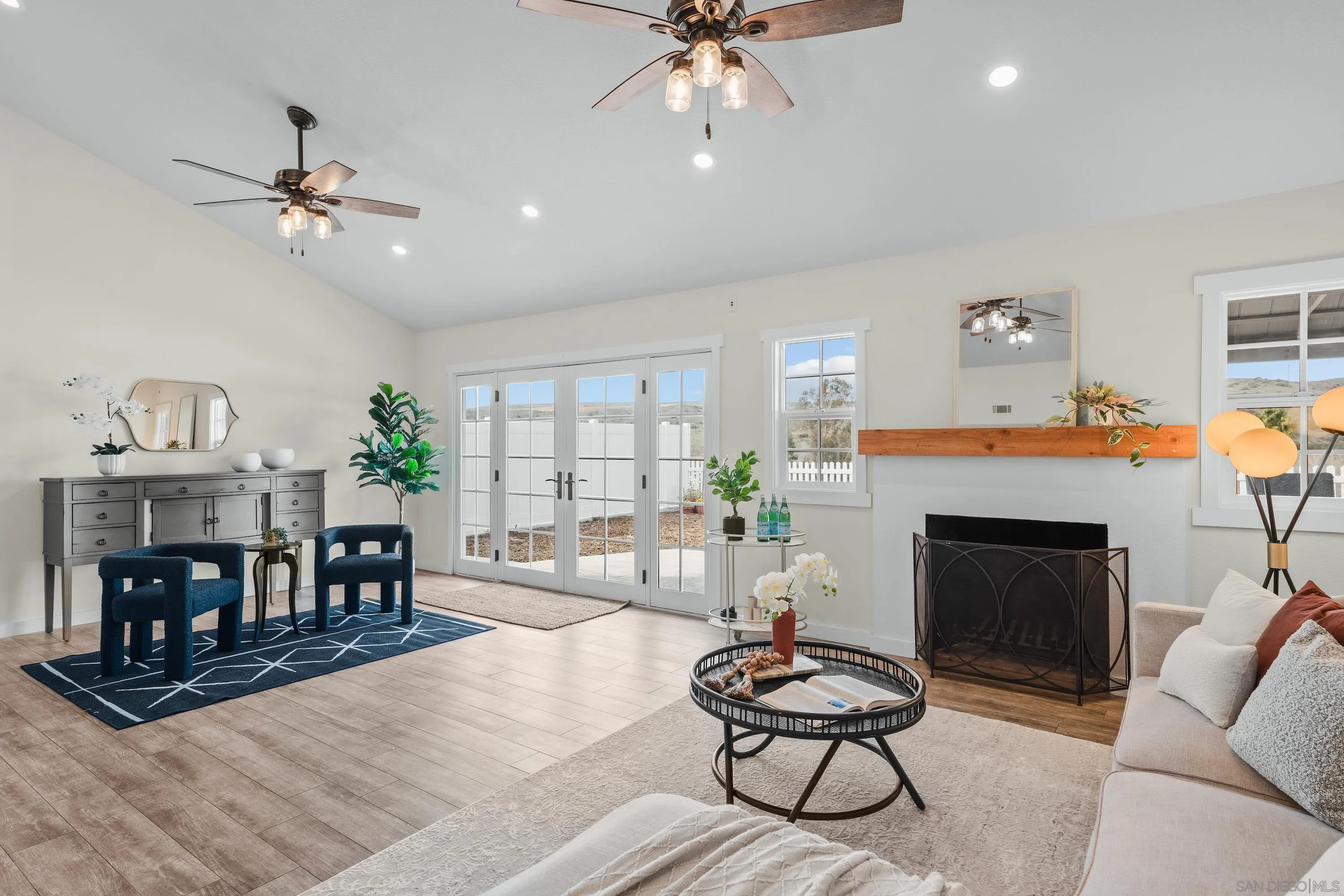 10472 Cadwell Road Santee, CA 92071 - Photo 11 of 30 a living room with furniture a fireplace and a chandelier