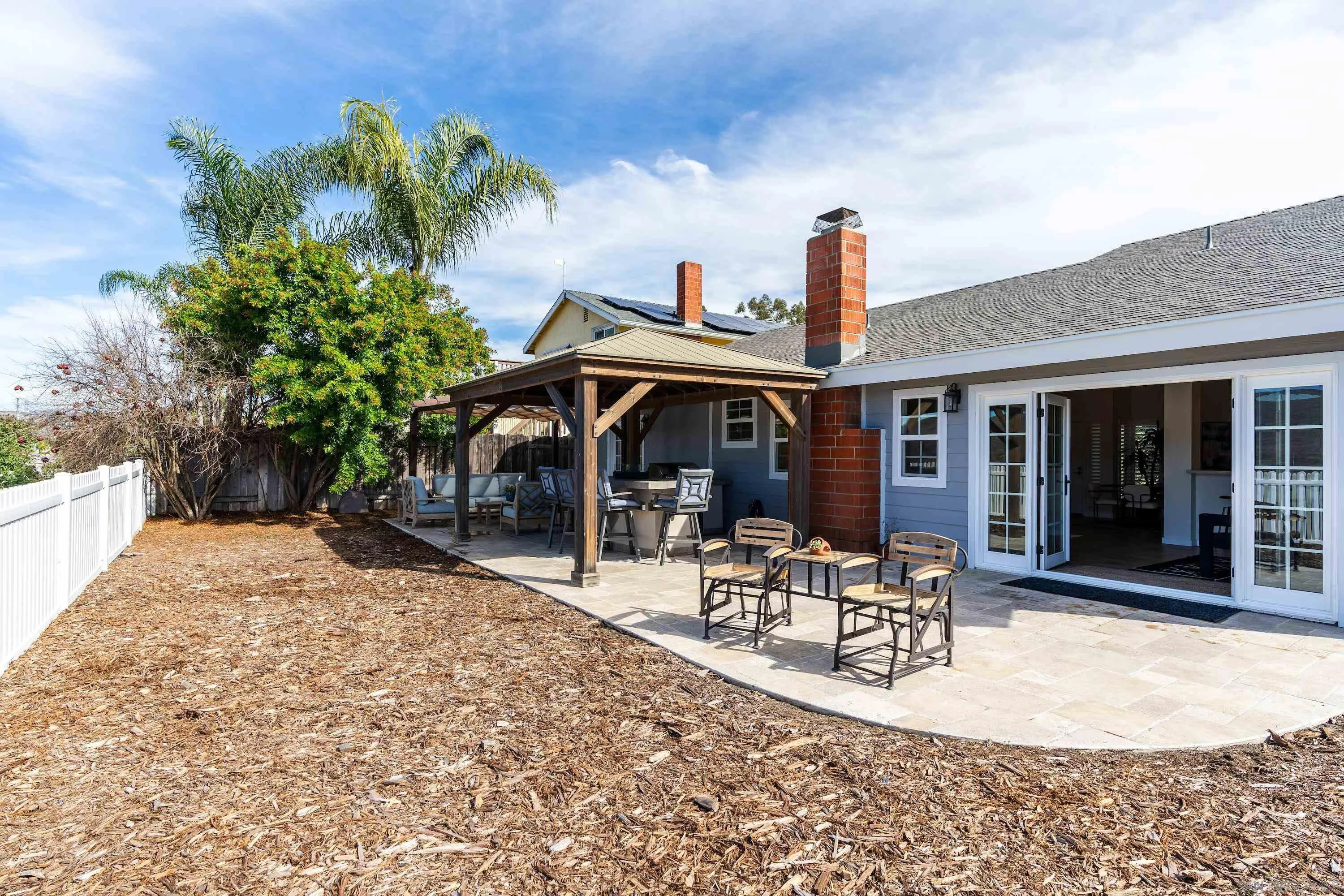 10472 Cadwell Road Santee, CA 92071 - Photo 16 of 30 a front view of a house with table and chairs potted plants