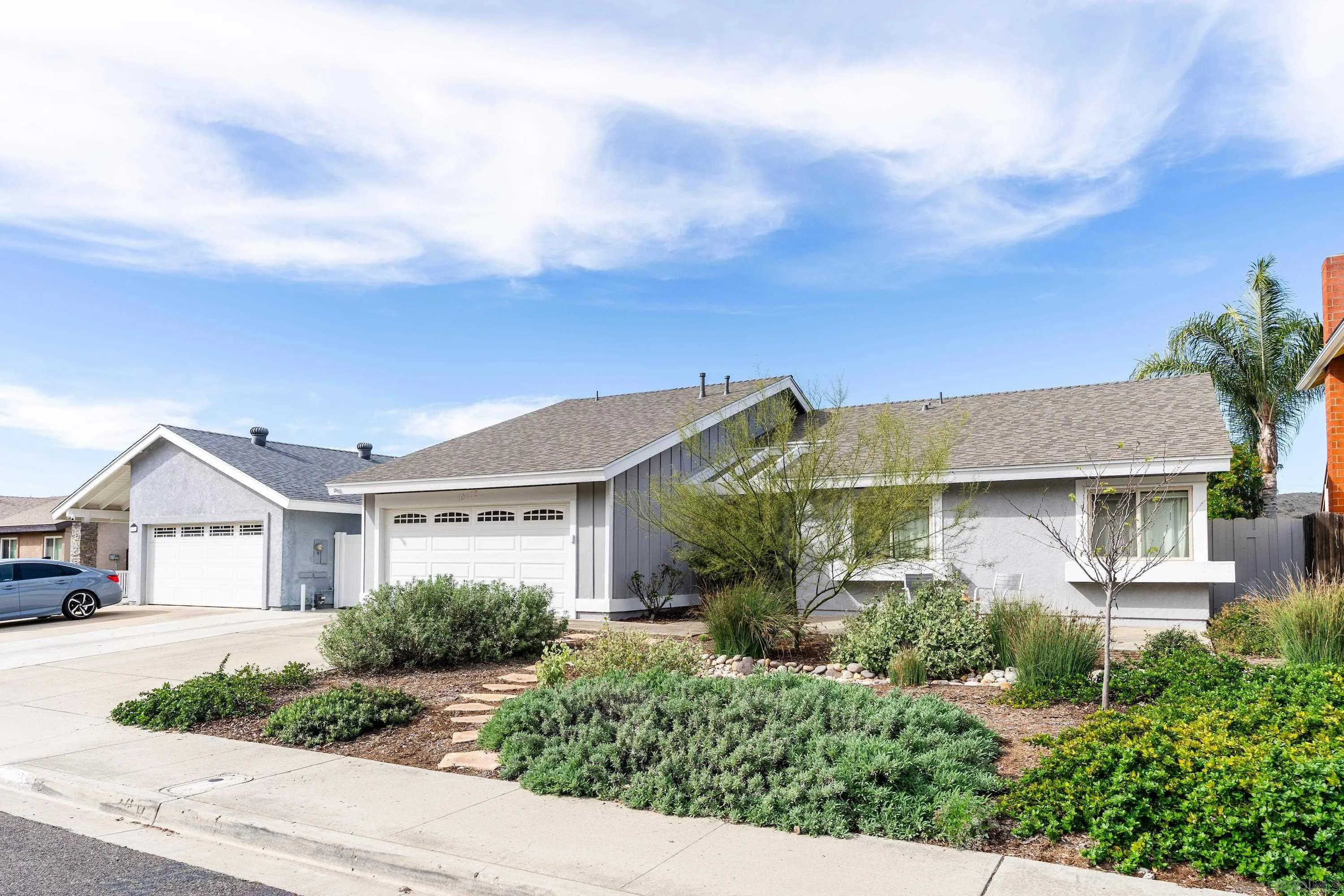10472 Cadwell Road Santee, CA 92071 - Photo 2 of 30 a view of house with garden and tall windows