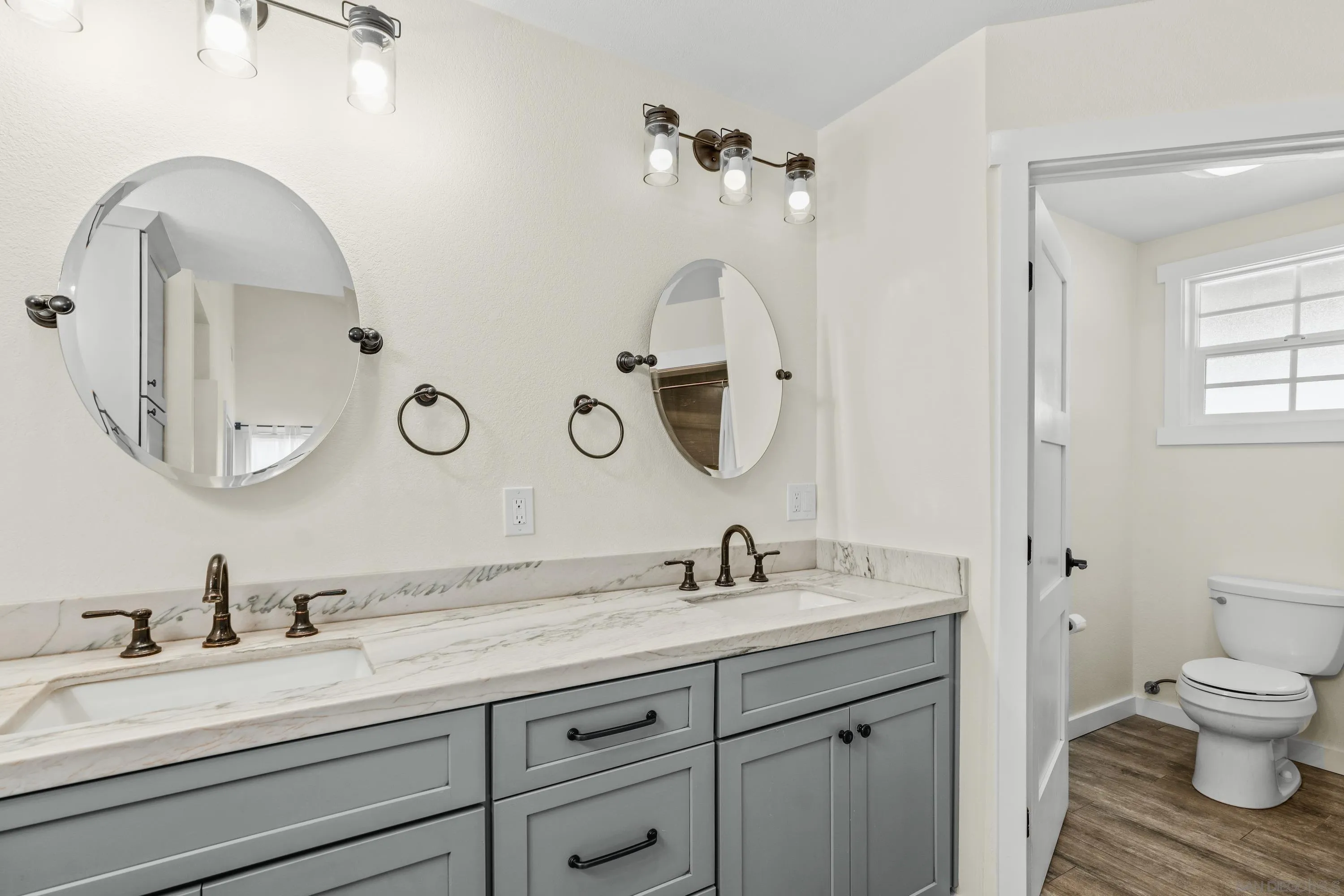 10472 Cadwell Road Santee, CA 92071 - Photo 21 of 30 a bathroom with a double vanity sink and a mirror