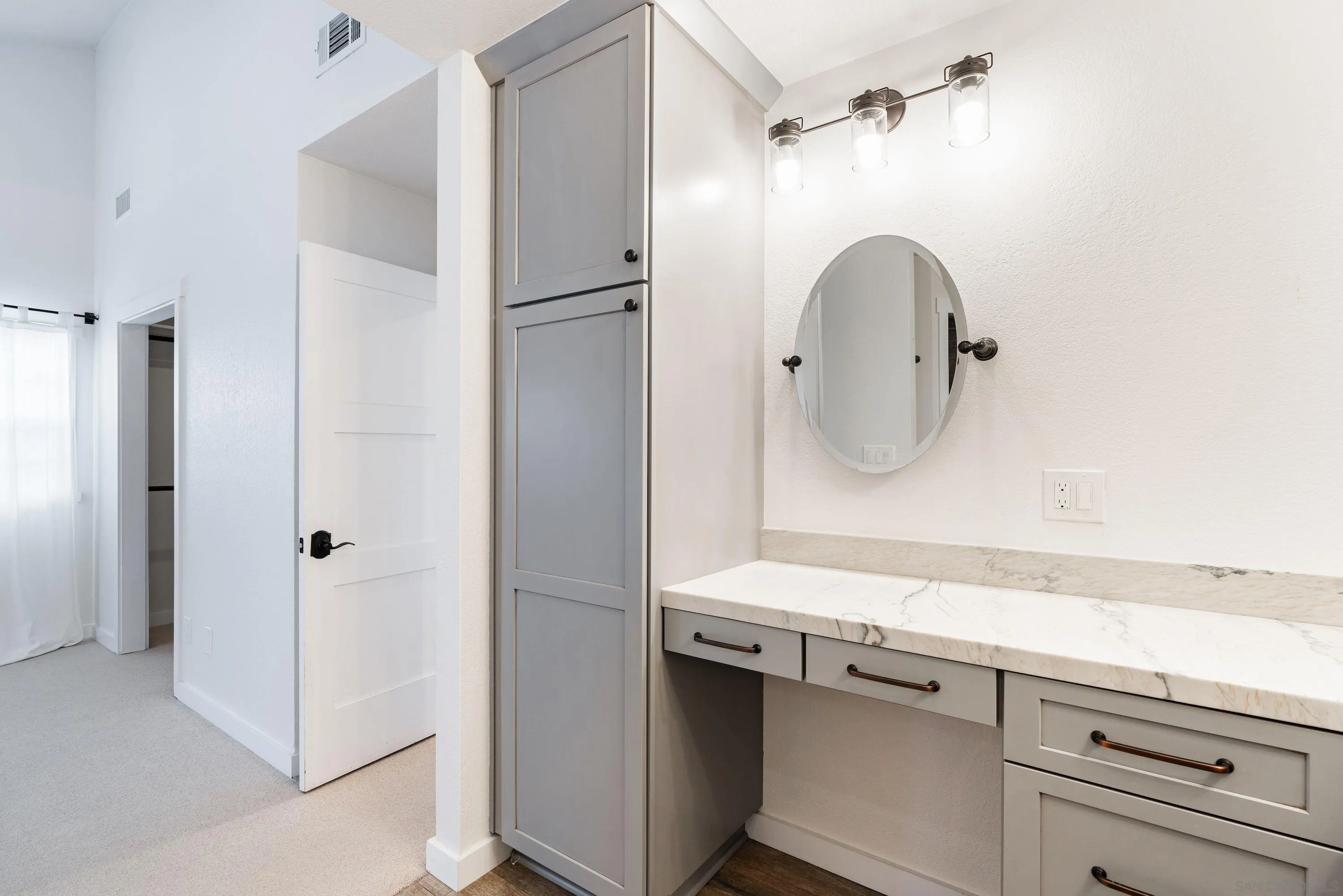10472 Cadwell Road Santee, CA 92071 - Photo 22 of 30 a bathroom with a sink a mirror a vanity and shower