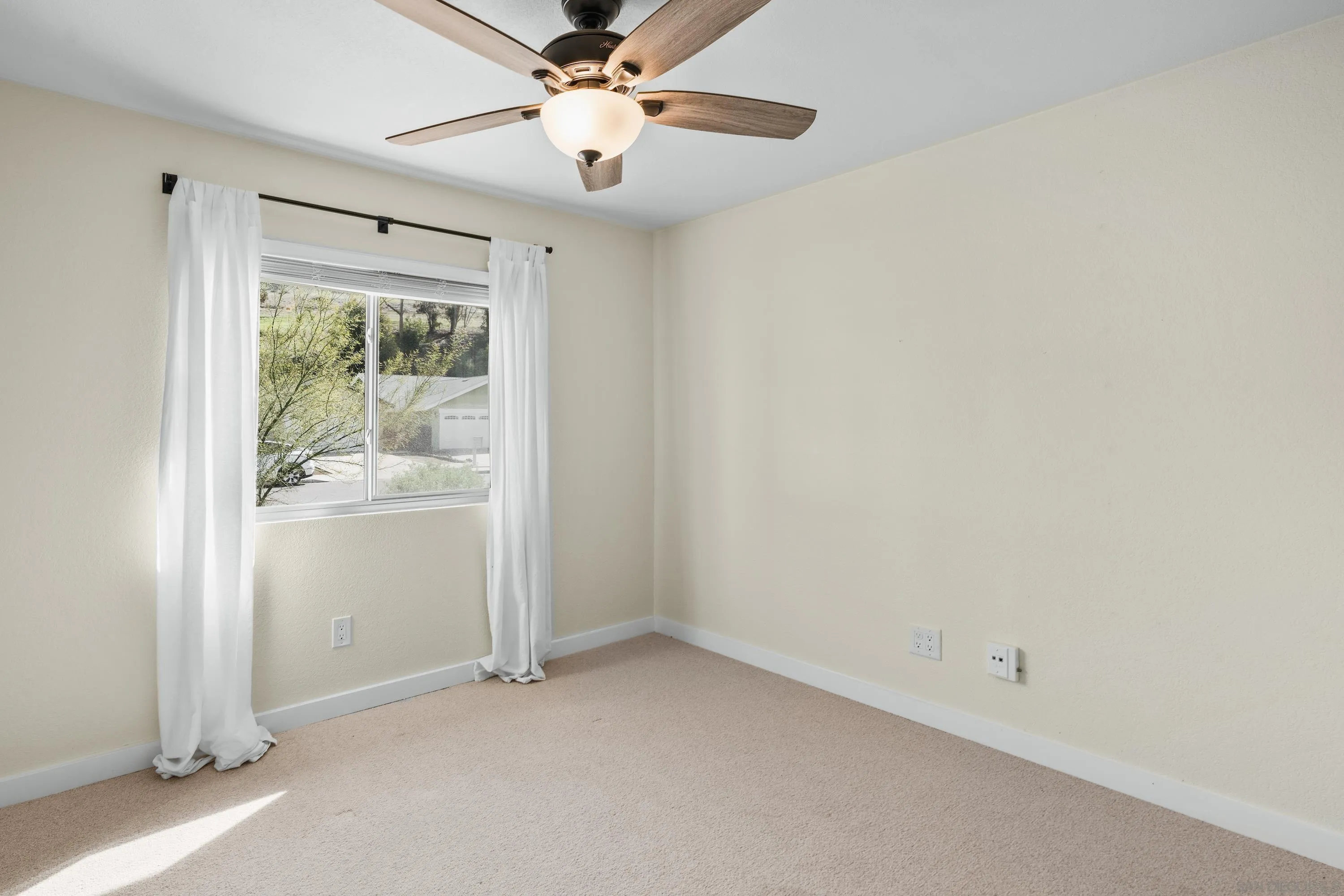 10472 Cadwell Road Santee, CA 92071 - Photo 26 of 30 an empty room with a window and a ceiling fan