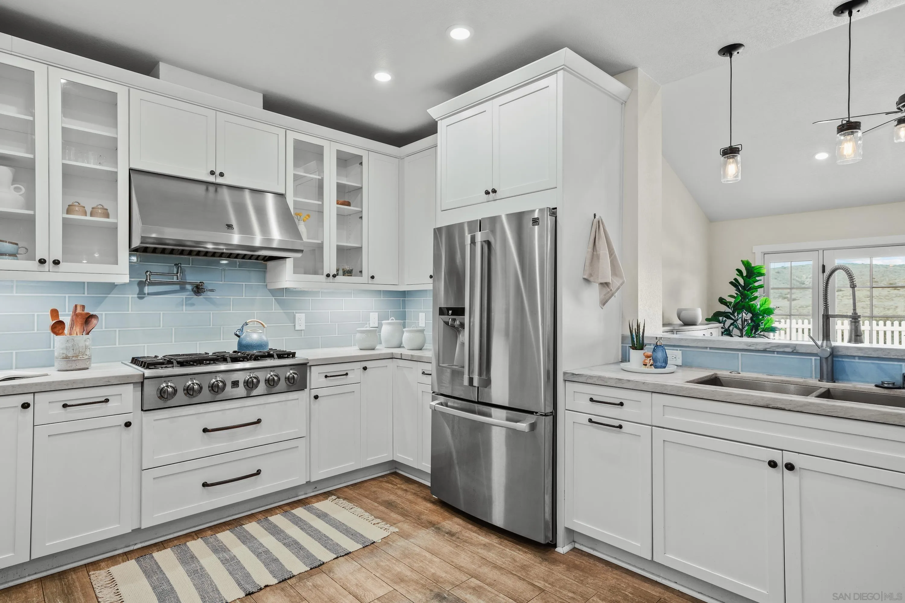 10472 Cadwell Road Santee, CA 92071 - Photo 6 of 30 a kitchen with appliances a sink and cabinets