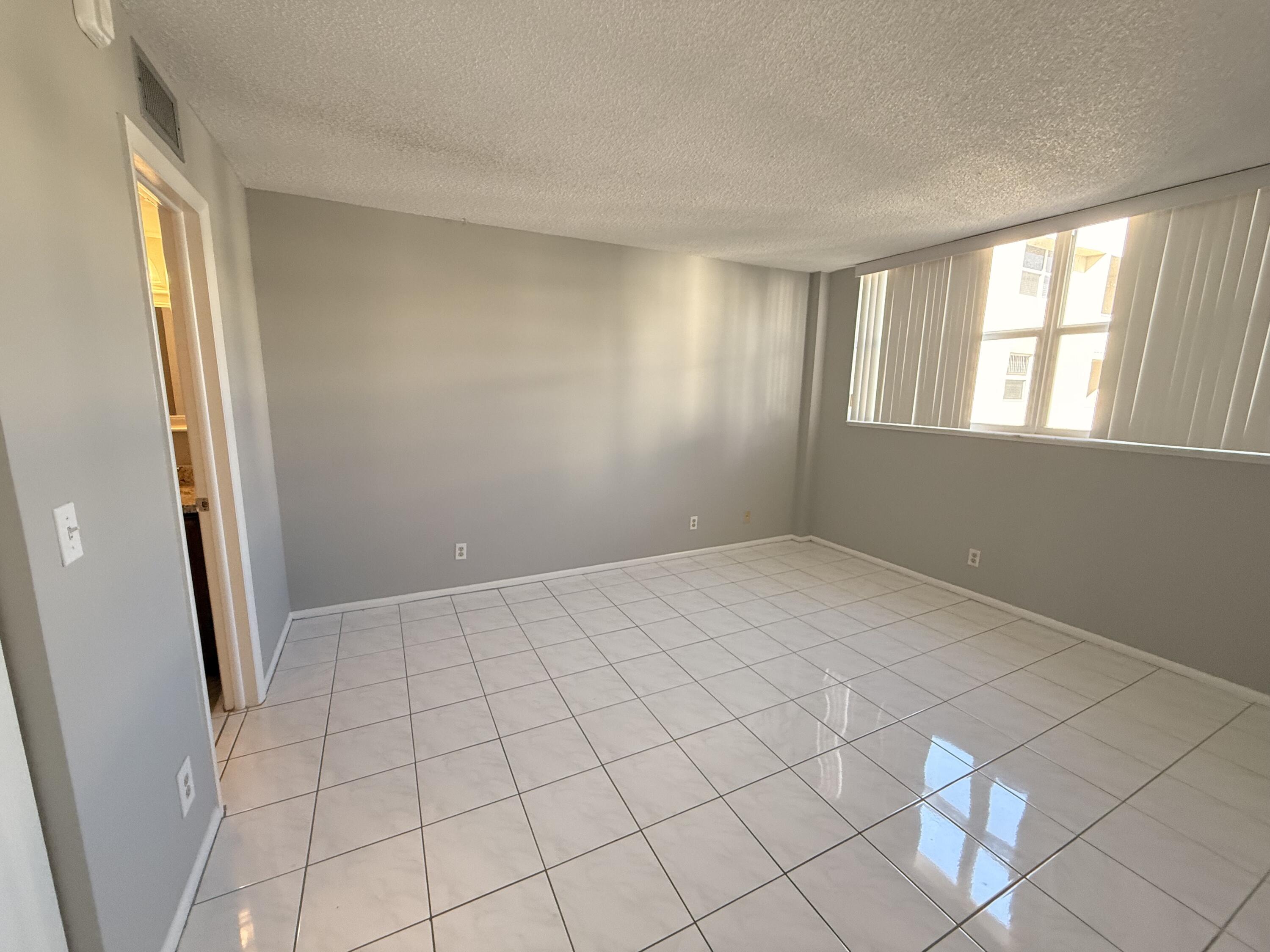 2929 South Ocean Boulevard, Unit 406 Boca Raton, FL 33432 - Photo 11 of 16 a view of an empty room and window