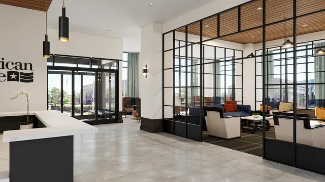 a living room with furniture tv and large windows