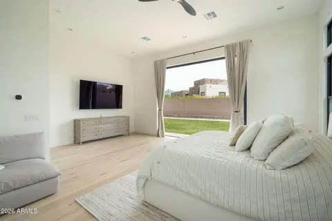 a bedroom with a large bed and a window
