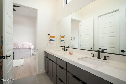 a bedroom with a bed and a large window