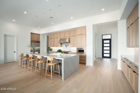 a living room with lots of furniture and a wooden floor