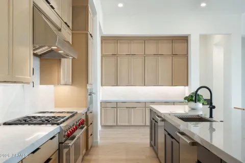 a large kitchen with lots of counter top space and stainless steel appliances