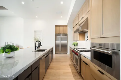 a kitchen with a sink stove and cabinets