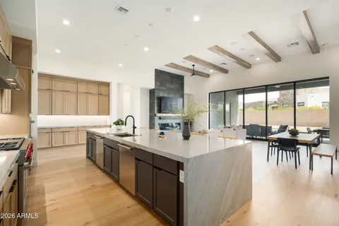 a kitchen with stainless steel appliances a sink stove and cabinets