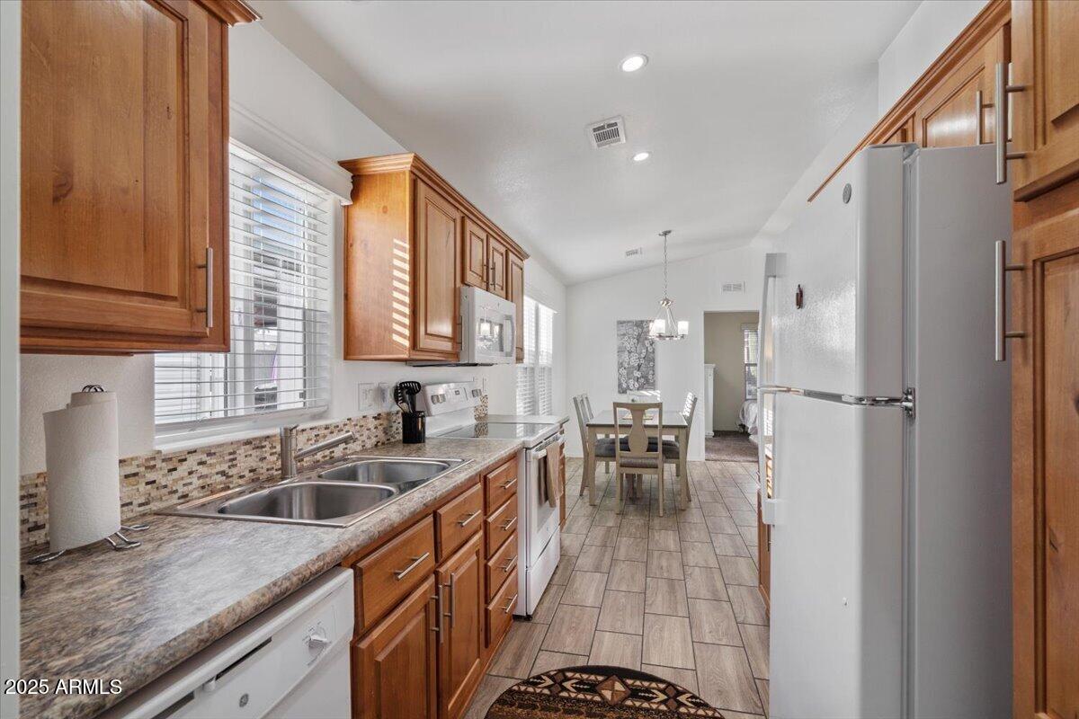 8865 East Baseline Road, Unit 1232 Mesa, AZ 85209 - Photo 12 of 38 a kitchen with a sink a counter top space and stainless steel appliances