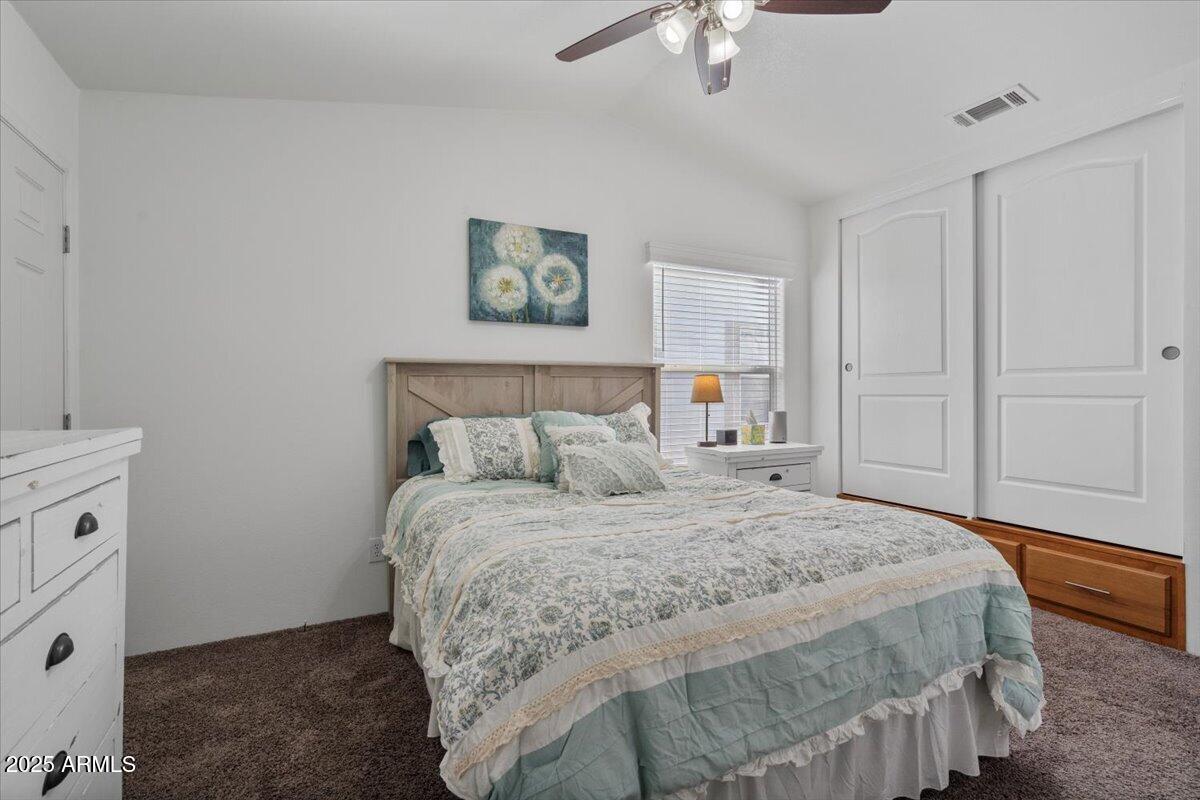 8865 East Baseline Road, Unit 1232 Mesa, AZ 85209 - Photo 13 of 38 a bedroom with a bed and a chandelier