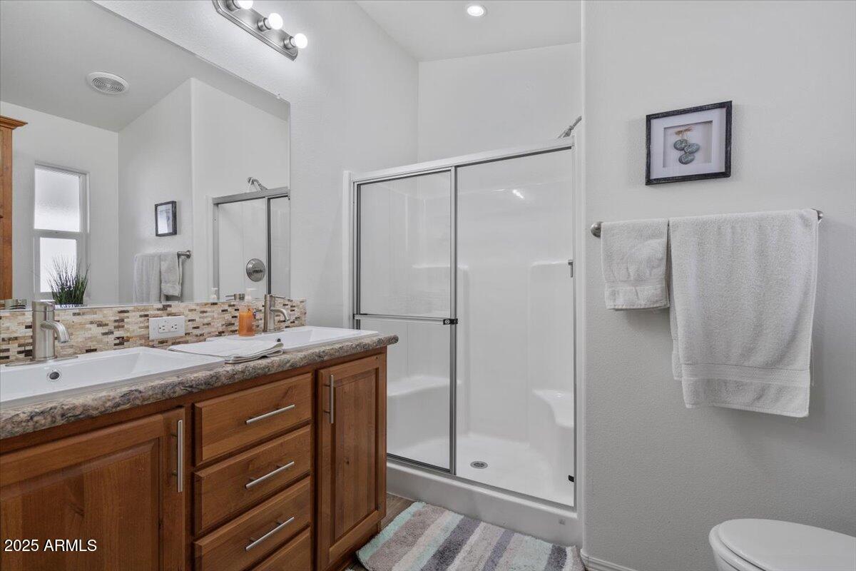 8865 East Baseline Road, Unit 1232 Mesa, AZ 85209 - Photo 14 of 38 a bathroom with a granite countertop sink toilet and shower