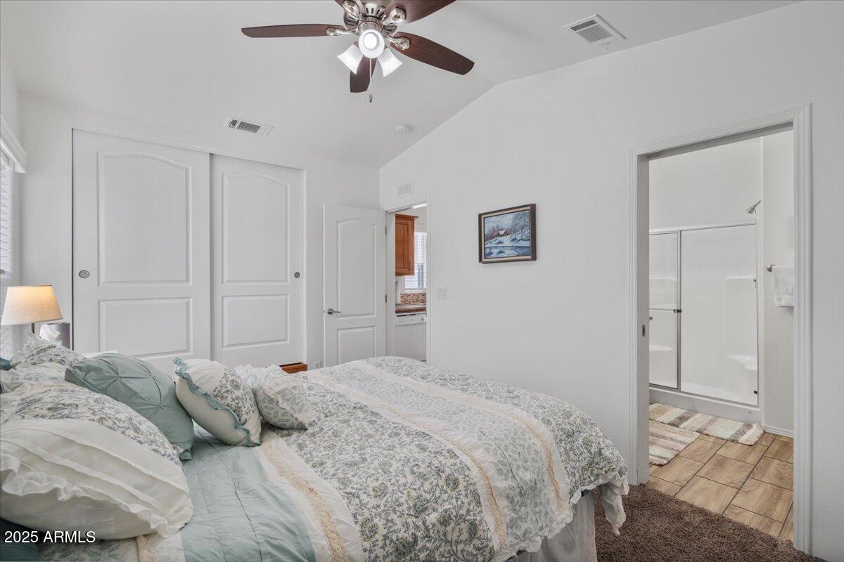 8865 East Baseline Road, Unit 1232 Mesa, AZ 85209 - Photo 16 of 38 a bedroom with a bed and a chandelier