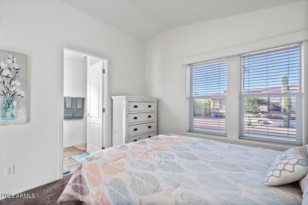 8865 East Baseline Road, Unit 1232 Mesa, AZ 85209 - Photo 18 of 38 a bedroom with a bed and a large window