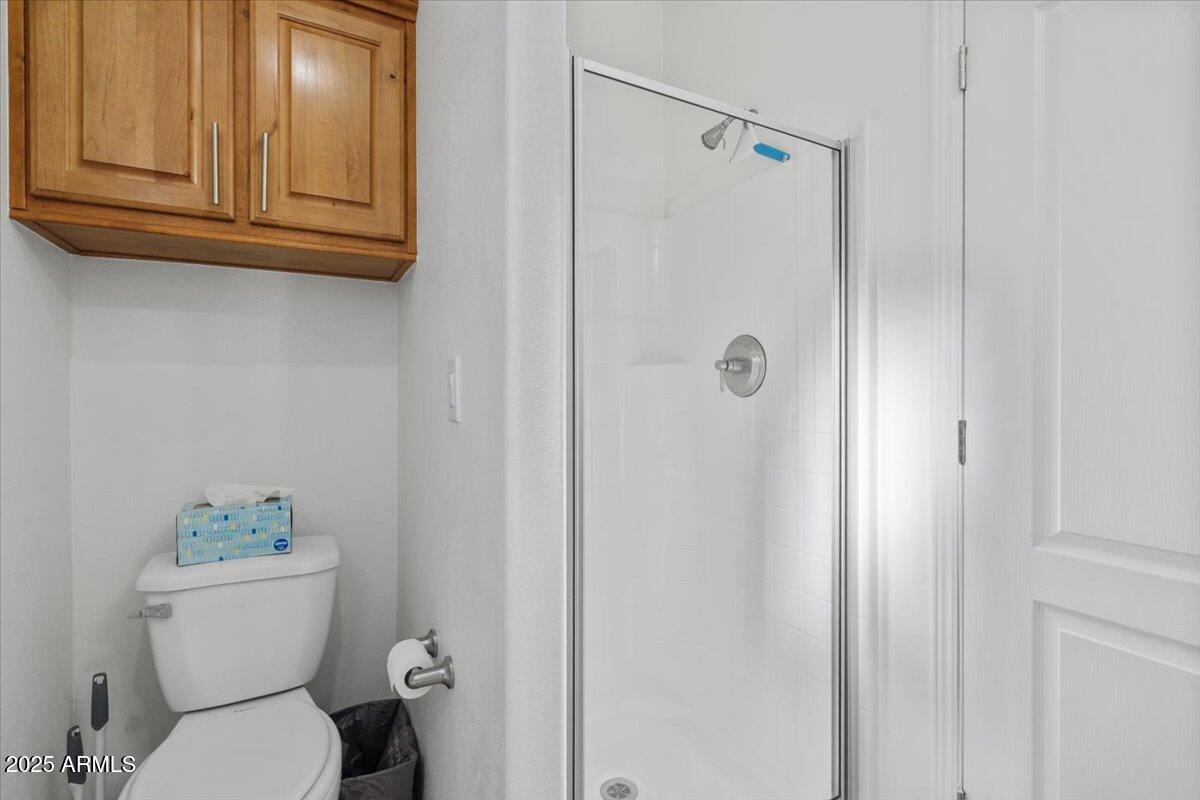 8865 East Baseline Road, Unit 1232 Mesa, AZ 85209 - Photo 20 of 38 a bathroom with a toilet and a shower