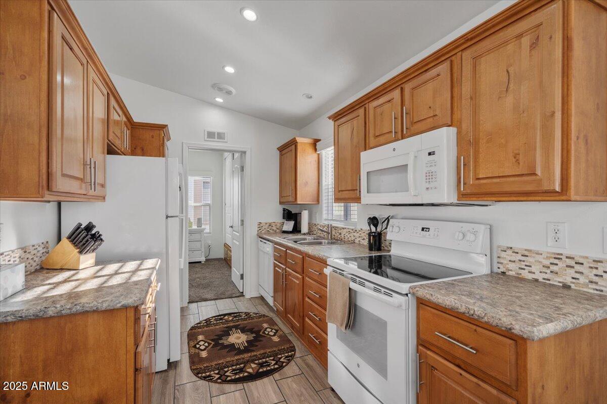 8865 East Baseline Road, Unit 1232 Mesa, AZ 85209 - Photo 4 of 38 a kitchen with a sink stove and cabinets