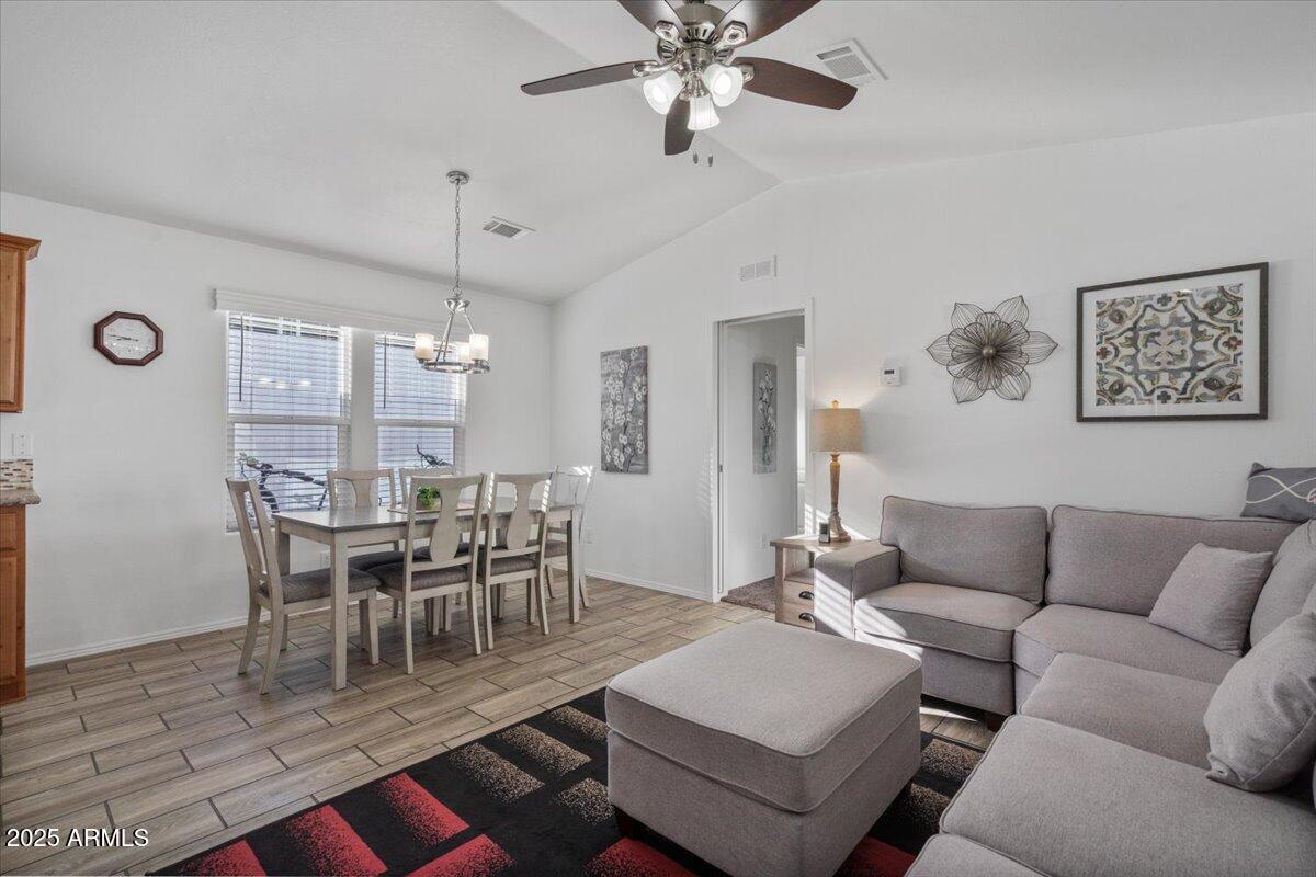 8865 East Baseline Road, Unit 1232 Mesa, AZ 85209 - Photo 8 of 38 a view of a dining room with furniture and wooden floor