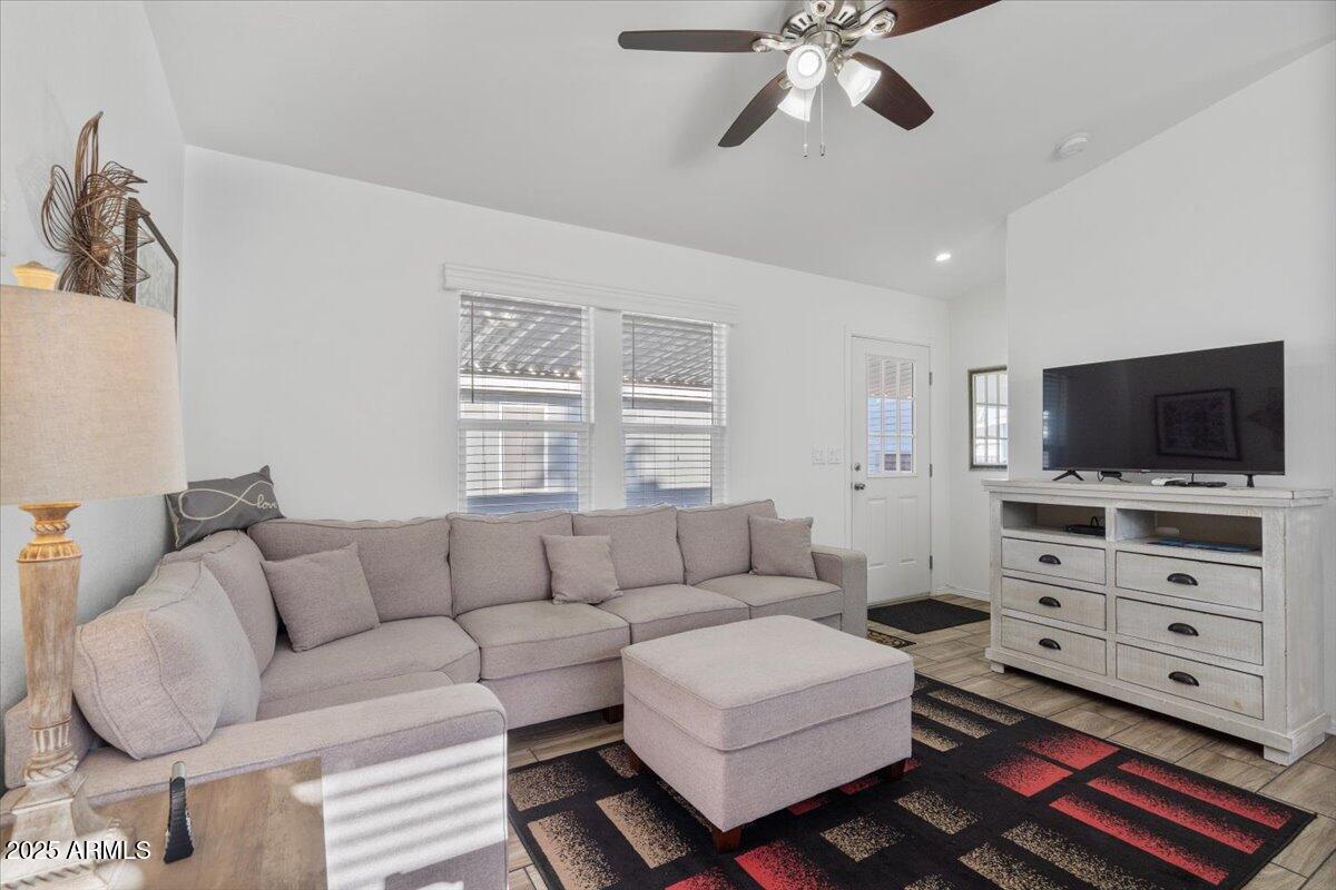 8865 East Baseline Road, Unit 1232 Mesa, AZ 85209 - Photo 9 of 38 a living room with furniture and a flat screen tv