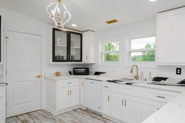 a kitchen with a sink cabinets and window