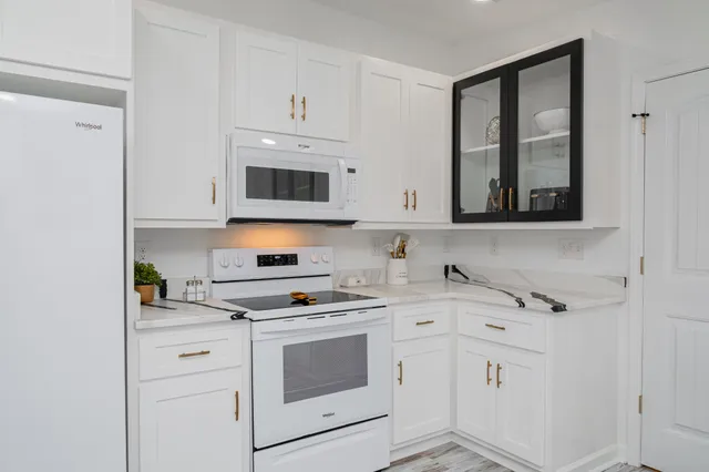 a kitchen with stainless steel appliances a stove microwave and cabinets