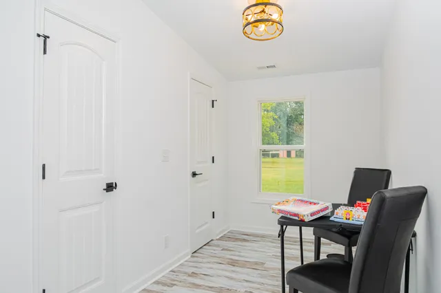 a view of a workspace with furniture and a window
