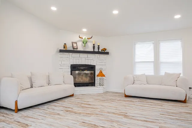 a living room with furniture and a fireplace
